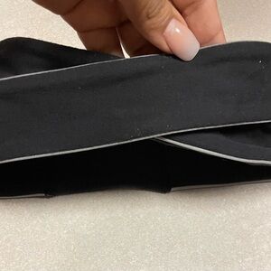 Black Lululemon Athletica headband. Interwoven at front. White trim.